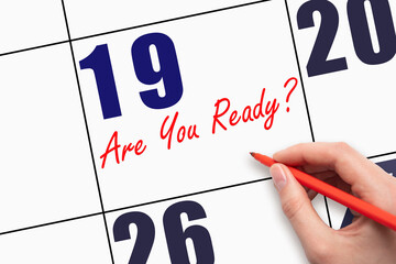 19th day of the month. Hand writing text ARE YOU READY on calendar date.