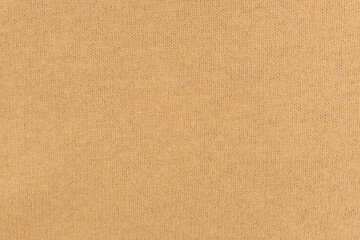 Fototapeta na wymiar Texture of warm ocher wool fabric close-up. Place for your design, or background for mockup