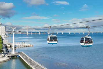 Cercles muraux Pont Vasco da Gama Telecabine Lisboa at Park of Nations. Vasco da Gama tower and Bridge in Lisbon. Cable car in the modern district of Lisbon over the Tagus river