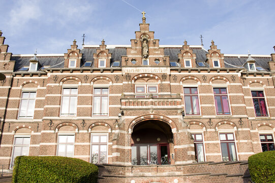 Main entrance of Elisabeths Gasthuis in Arnhem in the Netherlands with cirrus clouds. Elisabeths Gasthuis is a historic former hospital