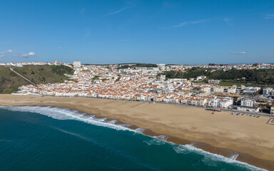 Fototapeta premium Nazare Town in Portugal. Beach and Cityscape. Drone Point of view.