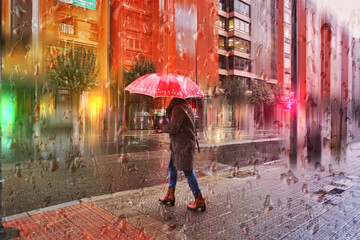 people with an umbrella in rainy days in winter season, bilbao, basque country, spain