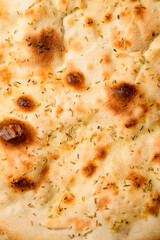 Close-up top view on round lavash with seasonings.