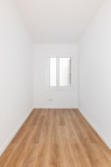 Long narrow rectangular room with white walls and wooden parquet, well lit by daylight from frosted glass window from prying eyes. Several sockets for electrical appliances are built into wall.