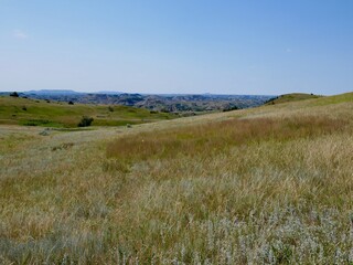 Grasslands in Theodore Roosevelt National Park, badlands in the background. North Dakota, USA.