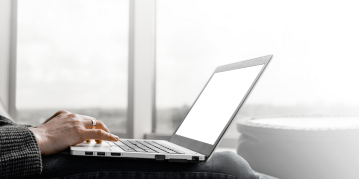  a businessman working in an office with large windows.