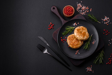 Grilled meatballs with spices and herbs or crepinette on a black plate