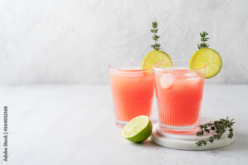 Wall mural Grapefruit and lime drink and cocktail with thyme