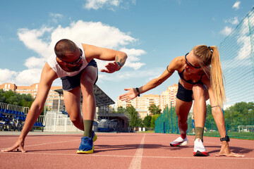 Man and woman at the start of the treadmill at the stadium