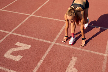 Woman athlete at the start of the treadmill. A start to a new life, the beginning of a new...