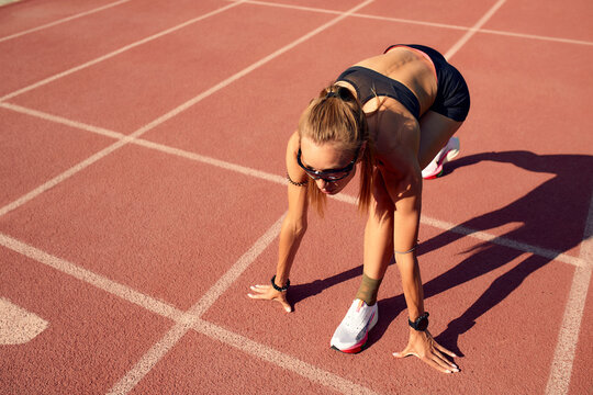 Woman athlete at the start of the treadmill. A start to a new life, the beginning of a new activity, a new life.