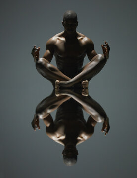 Black Man, Meditation And Mirror Reflection On Dark Background For Spiritual Wellness Or Symmetry. Portrait Of A Naked, Nude Or Bare African American Male Model Sitting And Meditating Doppelganger