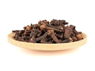 Cloves on a wooden plate isolated on a white background.