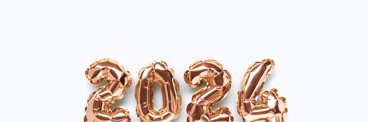 Banner with shiny 2024 gold inflatable balloons on a blue background with place for text. New Year's creative compisition.