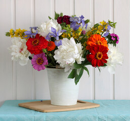 Obraz na płótnie Canvas peonies, irises, carnations and zinnias.