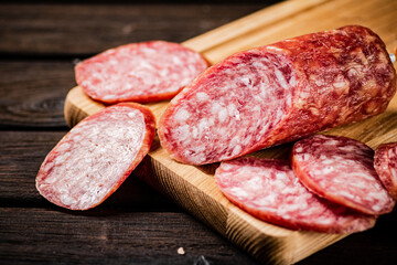 Sliced delicious salami sausage on the table. 