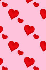 Repetitive pattern made of red hearts. Concept on a pink pastel background.
