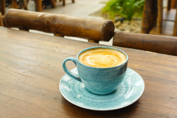 a cup of late coffee with flower shape design on top at cafe 
