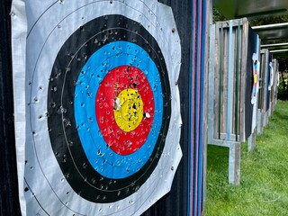 Row of archery targets on field.