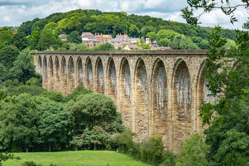 Railway viaduct with village in rear