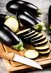 Cut into pieces of ripe eggplant on a wooden cutting board. 