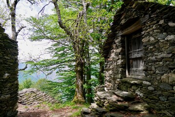 Rustici, traditional stone houses in the mountains at lake Maggiore. Piedmont, Italy.