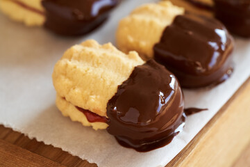 Homemade Christmas cookies filled with marmalade and dipped in chocolate