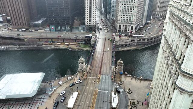 Aerial drone view flying in downtown Chicago loop over Magnificent Mile on cold snowy winter day
