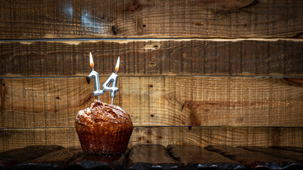 Background happy birthday pie or muffin with candles burning digit number  14. Festive card Happy...