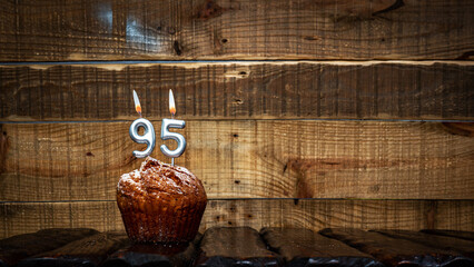 Background happy birthday pie or muffin with candles burning digit number  95. Festive card Happy...