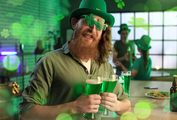 Funny bearded man with glasses of beer celebrating St. Patrick's Day in pub