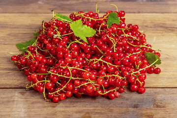 Healthy food. Red currants in bulk on wooden background. Organic berries. View directly from the top