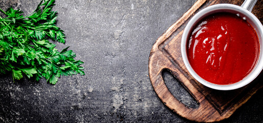 Tomato sauce on a wooden cutting board. 