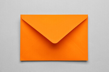 Orange paper envelope on light background