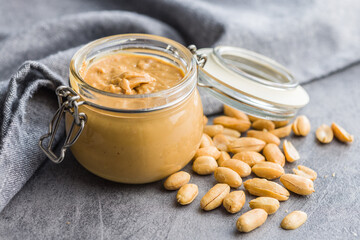 Peanut butter in jar on kitchen table.
