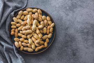 Unpeeled peanuts on kitchen table.