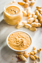 Peanut butter in bowl on kitchen table.