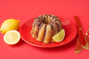 Plate with delicious cake and lemons on red background