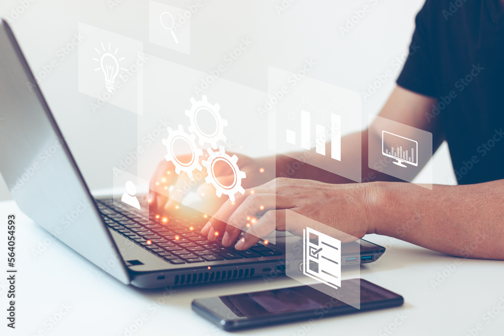 Wall mural automation concept. optimise business process workflow. business people typing on laptop computer ke