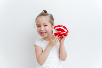 Cute happy caucasian toddler girl playing  with dentist. Medical stomatology. Dental, oral care,healthcare concept. White background.