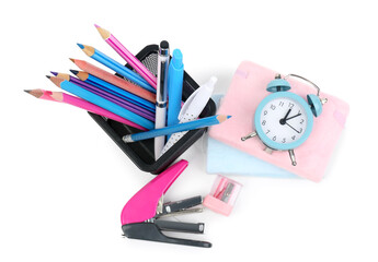 Stationery holder, notebooks with clock, stapler and sharpener on white background