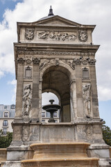 Fototapeta na wymiar Fountain of the Innocents (Fontaine des Innocents, 1547 - 1550) at place Joachim-du-Bellay in Paris. Fountain of the Innocents is oldest monumental fountain in Paris, France.