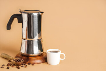 Geyser coffee maker, beans and cup on beige background