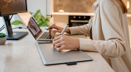 Close up of female designer works in home office drawing on graphic tablet. Freelancer working on project, watching movie on computer, studying, blogging, relaxing and chatting online - 564056574