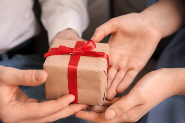 Woman receiving gift from her boyfriend at home. Valentine's Day celebration
