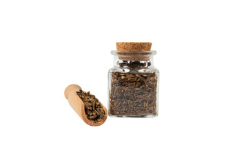 Valerian herb root in wooden scoop and glass jar isolated on white background. Valeriana officinalis. used in herbal medicine as a tranquilizer and to treat insomnia, anxiety, hypertension, pain