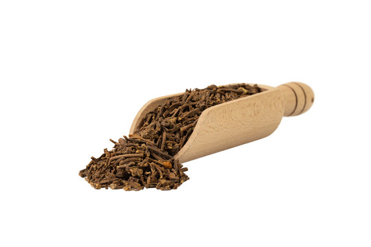 Valerian herb root  in wooden scoop isolated on white background. Valeriana officinalis. used in herbal medicine as a tranquillizer and to treat insomnia, anxiety, hypertension, pain relief.