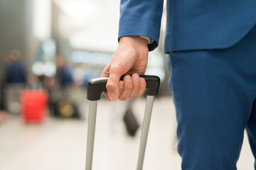 Detail of a traveler pushing his trolley