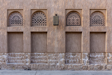 Arabic style window portals in stone wall with ornaments, traditional arabic architecture, Al...