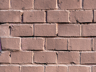 Old brick wall painted brown. Texture of rough brickwork. Masonry background.